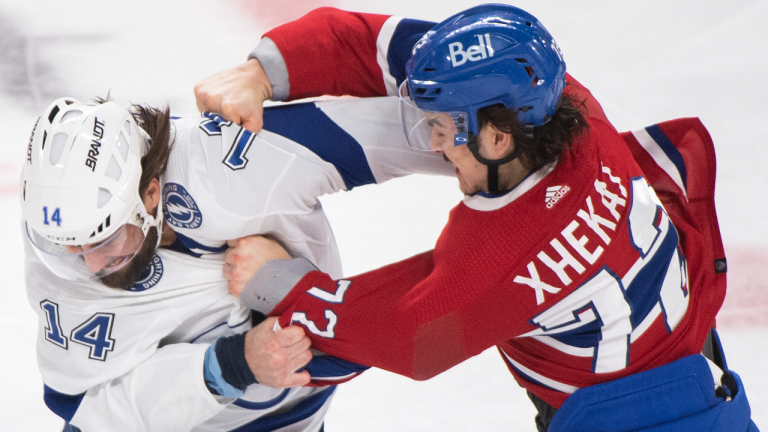 Montreal Canadiens' Arber Xhekaj, right, fights with Tampa Bay Lightning's Pat Maroon during first period NHL hockey action in Montreal, Saturday, December 17, 2022. THE CANADIAN PRESS/Graham Hughes