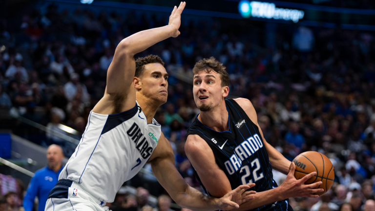 Orlando Magic forward Franz Wagner (22) battles Dallas Mavericks forward Dwight Powell (7) for space during the second half of an NBA basketball game, Sunday, Oct. 30, 2022, in Dallas. Dallas won 114-105. (AP)