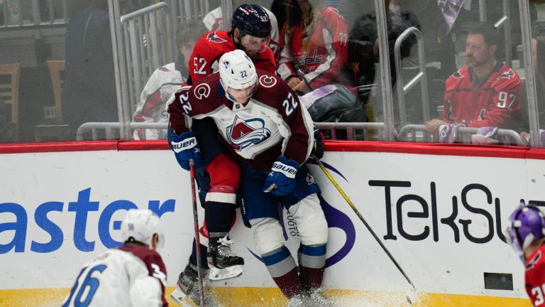 Colorado Avalanche left wing Dryden Hunt (22) collides with Washington Capitals defenseman Matt Irwin (52) while reaching for the puck during the third period of an NHL hockey game. (Jess Rapfogel/AP)