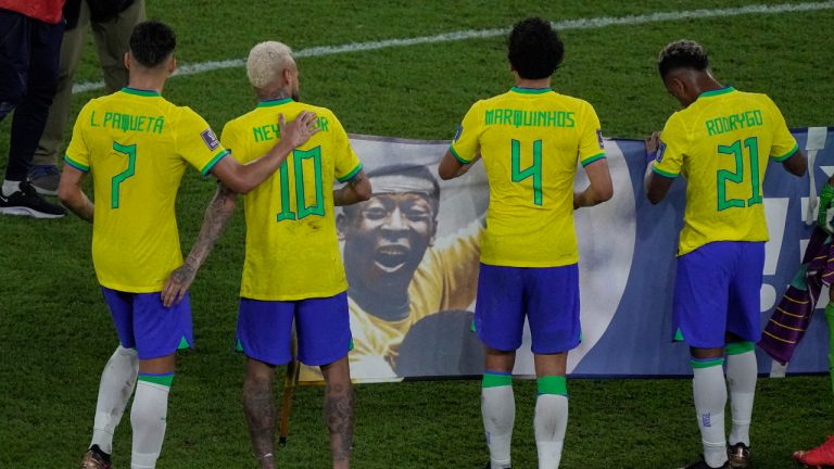 Brazil's Neymar, second left, holds with teammates a banner in support of Brazilian soccer legend Pele after the end of the World Cup round of 16 soccer match between Brazil and South Korea, at the Stadium 974 in Doha, Qatar, Monday, Dec. 5, 2022.(AP Photo/Darko Bandic)