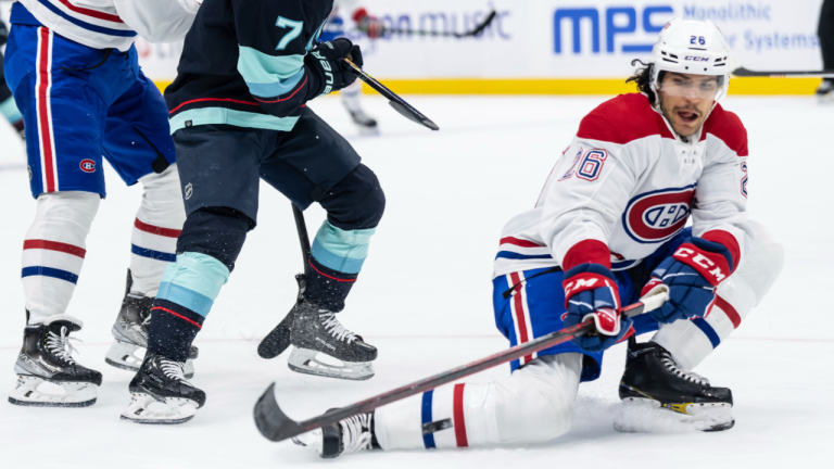 Montreal Canadiens defenseman Johnathan Kovacevic, right, knocks the puck away from Seattle Kraken forward Jordan Eberle during the second period of an NHL hockey game Tuesday, Dec. 6, 2022, in Seattle. (AP)