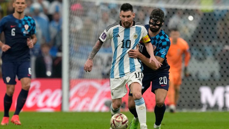 Argentina's Lionel Messi runs with the ball away from Croatia's Josko Gvardiol, right, during the World Cup semifinal soccer match between Argentina and Croatia at the Lusail Stadium in Lusail, Qatar, Tuesday, Dec. 13, 2022. (Frank Augstein/AP)