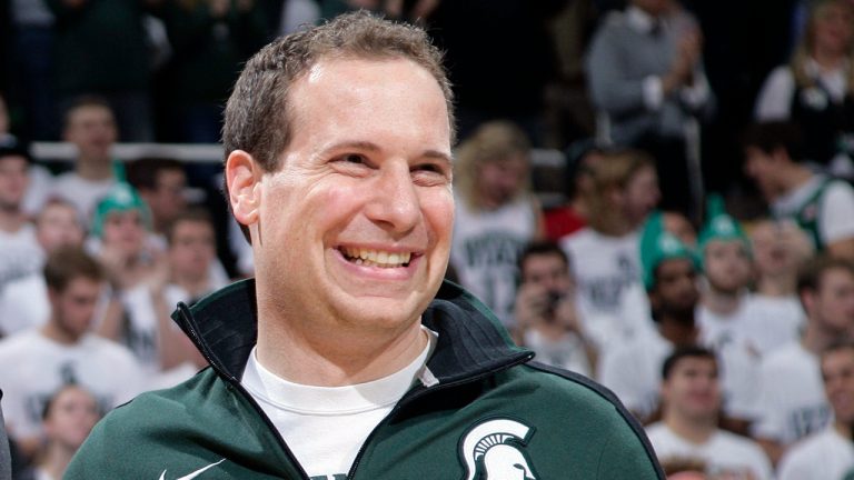 Former Michigan State player Mat Ishbia laughs as he is introduced along with Michigan State's 2000 national championship NCAA college basketball team during halftime of the Michigan State-Florida game in East Lansing, Mich. (Al Goldis/AP)