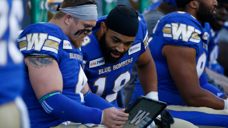 Winnipeg Blue Bombers' Adam Bighill (4) and Kyrie Wilson (19) look at film during the first half of CFL action against the Edmonton Eskimos in Winnipeg Friday, May 31, 2019. (CP)