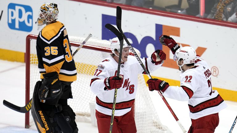 Carolina Hurricanes' Brett Pesce (22) celebrates his game-winning, overtime goal with Andrei Svechnikov as Pittsburgh Penguins goaltender Tristan Jarry (35) heads for the locker room during the overtime period of an NHL hockey game in Pittsburgh, Tuesday, Nov. 29, 2022. The Hurricanes won 3-2 in overtime. (Gene J. Puskar/AP)