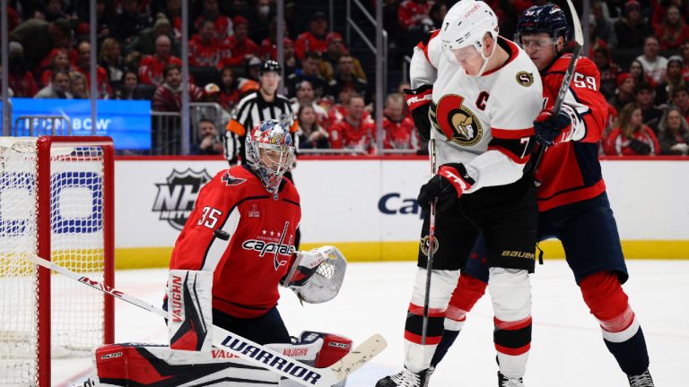 The puck flies by Washington Capitals goaltender Darcy Kuemper (35) next to Ottawa Senators left wing Brady Tkachuk (7) during the second period of an NHL hockey game, Thursday, Dec. 29, 2022, in Washington. Capitals defenseman Erik Gustafsson is at right. (Nick Wass/AP)