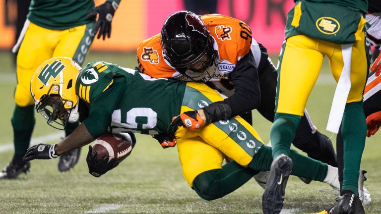 B.C. Lions' Mathieu Betts (90) tackles Edmonton Elks' Christian Saulsberry (25) during second half CFL action. (Jason Franson/CP)