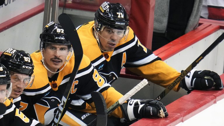 Pittsburgh Penguins' Sidney Crosby and Evgeni Malkin sit on the bench during the third period of an NHL hockey game against the Carolina Hurricanes in Pittsburgh, Tuesday, Nov. 29, 2022. The Hurricanes won 3-2 in overtime. (Gene J. Puskar/AP)