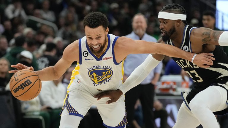 Golden State Warriors' Stephen Curry drives past Milwaukee Bucks' Wesley Matthews during the first half of an NBA basketball game Tuesday, Dec. 13, 2022, in Milwaukee. (Morry Gash/AP)