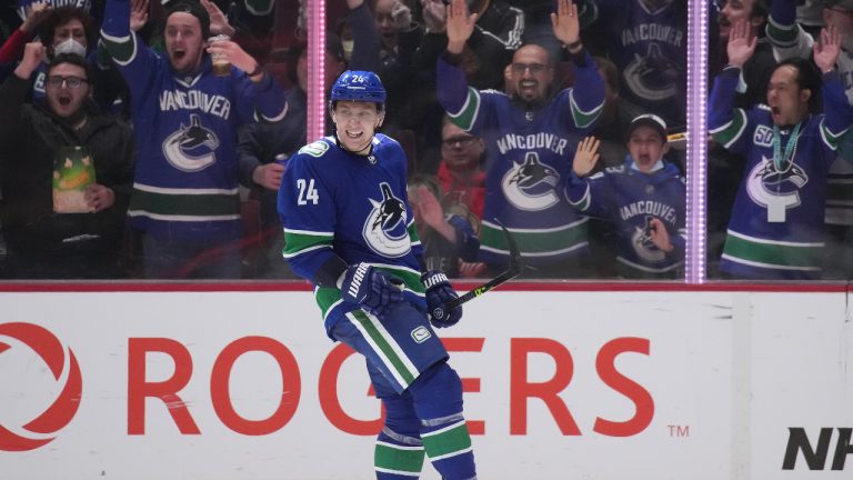 Vancouver Canucks' Travis Dermott celebrates his goal against the Ottawa Senators during the third period of an NHL hockey game in Vancouver, B.C., Tuesday, April 19, 2022. (Darryl Dyck/CP)