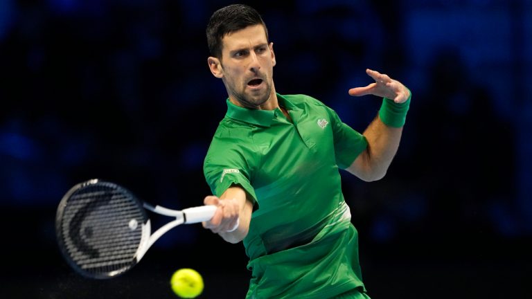 Serbia's Novak Djokovic returns the ball to Greece's Stefanos Tsitsipas during their singles tennis match of the ATP World Tour Finals, at the Pala Alpitour in Turin, Italy, Monday, Nov. 14, 2022. (Antonio Calanni/AP)