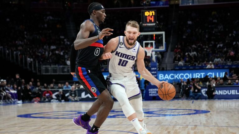 Sacramento Kings forward Domantas Sabonis drives on Detroit Pistons center Jalen Duren in the second half of an NBA basketball game in Detroit, Friday, Dec. 16, 2022. (Paul Sancya/AP Photo)