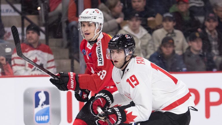 Switzerland's Nicolas Baechler and Canada's Adam Fantilli skate close to each other during first period IIHF World Junior Hockey Championship pre-tournament hockey action in Moncton, N.B., on Monday, Dec. 19, 2022. (Ron Ward/The Canadian Press)