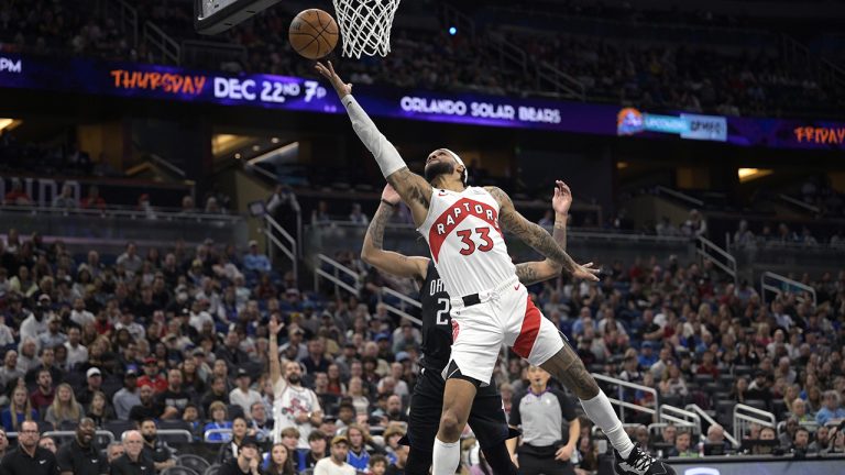 Toronto Raptors forward Bruce Brown (11) and Orlando Magic guard Jalen Suggs (4) vie for control of the ball during first half NBA basketball. (Frank Gunn/THE CANADIAN PRESS)