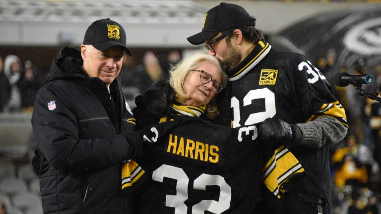 Pittsburgh Steelers owner Art Rooney II, left, and Franco Harris' widow Dana, center, and son Dok, attend a ceremony to retire Harris' No. 32 jersey at half-time of an NFL football game against the Las Vegas Raiders, Saturday, Dec. 24, 2022. Harris, a four-time Super Bowl champion, passed away Dec. 21, 2022, at the age of 72. (Don Wright/AP)