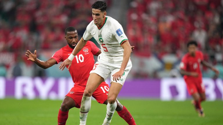 Morocco defender Nayef Aguerd (5) moves the ball as Canada midfielder Junior Hoilett (10) defends during first half group F World Cup soccer action at the Al Thumama Stadium in Doha, Qatar on Thursday, December 1, 2022. (Nathan Denette/CP)