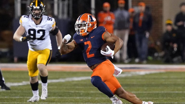 Illinois running back Chase Brown carries the ball during the first half of an NCAA college football game against the Iowa Saturday, Oct. 8, 2022, in Champaign, Ill.&nbsp;Brown has been awarded the Jon Cornish Trophy as the top Canadian in NCAA football (Charles Rex Arbogast/AP)