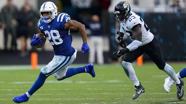 Indianapolis Colts running back Jonathan Taylor (28) get past Jacksonville Jaguars linebacker Foyesade Oluokun (23) for a gain during the second half of an NFL football game, Sunday, Sept. 18, 2022, in Jacksonville, Fla. (John Raoux/AP)