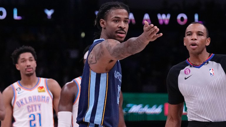 Memphis Grizzlies guard Ja Morant, center, talks to referee Phenizee Ransom, right, after receiving a technical foul in the first half of an NBA basketball game Saturday, Dec. 17, 2022, in Oklahoma City. Looking on at left is Oklahoma City Thunder guard Aaron Wiggins (21). (Sue Ogrocki/AP)