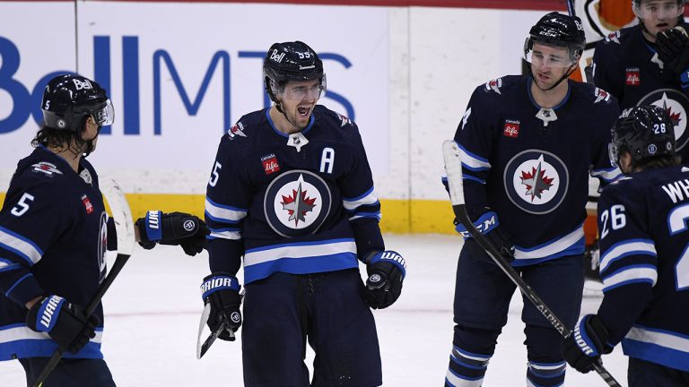 Winnipeg Jets' Mark Scheifele (55) celebrates his goal against the Anaheim Ducks with teammates during third period NHL action in Winnipeg on Sunday, December 4, 2022. (Fred Greenslade/CP)