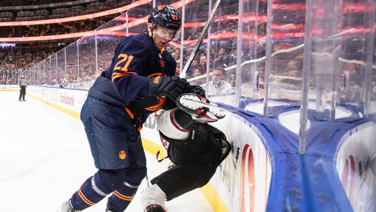 Arizona Coyotes' Josh Brown (3) is checked by Edmonton Oilers' Klim Kostin (21) during first period NHL action in Edmonton on Wednesday, December 7, 2022. (Jason Franson/CP)