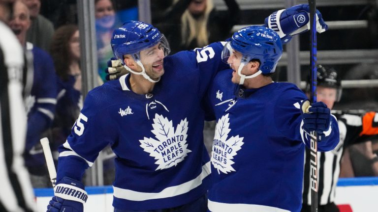 Toronto Maple Leafs' Alexander Kerfoot, right, celebrates his goal against the Anaheim Ducks with teammate Mark Giordano during third period NHL hockey action in Toronto on Tuesday, December 13, 2022. (Frank Gunn/CP)