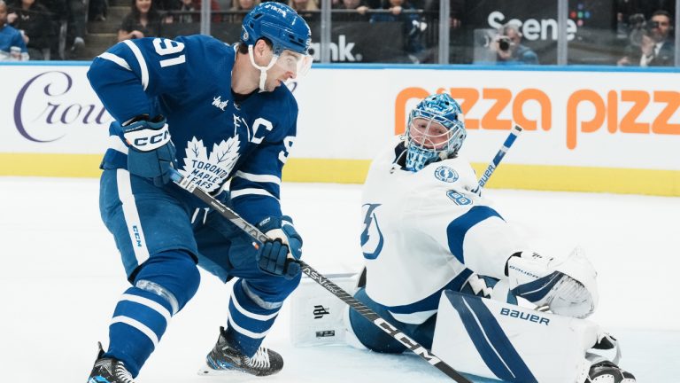 Tampa Bay Lightning goaltender Andrei Vasilevskiy stretches to stop Toronto Maple Leafs' John Tavares during second period NHL hockey action in Toronto, on Tuesday, December 20, 2022. (Chris Young/CP)