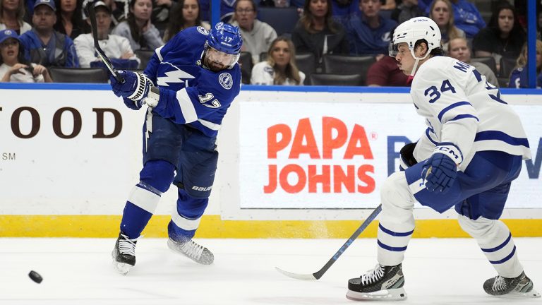 Tampa Bay Lightning left wing Alex Killorn (17) scores on a shot in front of Toronto Maple Leafs center Auston Matthews (34) during overtime in an NHL hockey game Saturday, Dec. 3, 2022, in Tampa, Fla. (Chris O'Meara/AP)