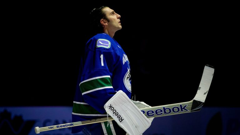 Former Vancouver Canucks goaltender Roberto Luongo looks on during the singing of "O Canada" before playing the Edmonton Oilers in an NHL hockey game. (Darryl Dyck/CP)