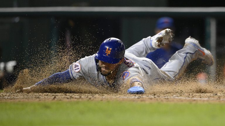 Former New York Mets outfielder Michael Conforto slides home to score on a double by Kevin Pillar during the 10th inning of the team's baseball game against the Washington Nationals, Friday, Sept. 3, 2021, in Washington. The Mets won 6-2 in 10 innings. (Nick Wass/AP)