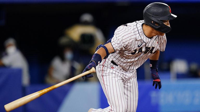 Japan's Masataka Yoshida follows through after hitting a RBI single during a semi-final baseball game against South Korea at the 2020 Summer Olympics, Wednesday, Aug. 4, 2021, in Yokohama, Japan. (Matt Slocum/AP)