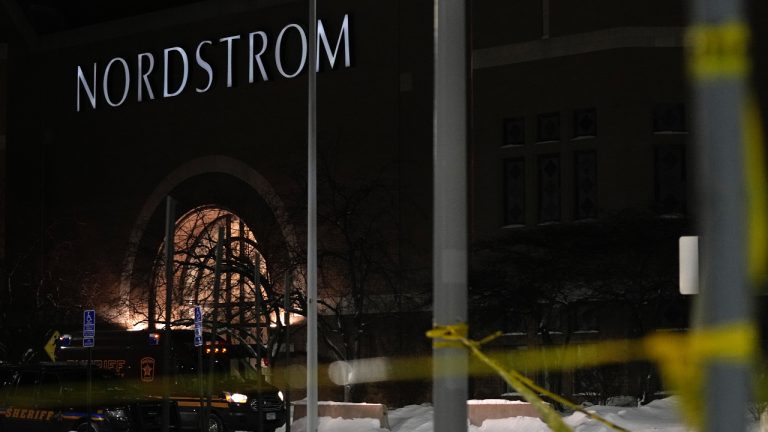 Caution tape and police cars are seen outside Nordstrom at Mall of America after a shooting, Friday, Dec. 23, 2022, in Bloomington, Minn. (Abbie Parr/AP)