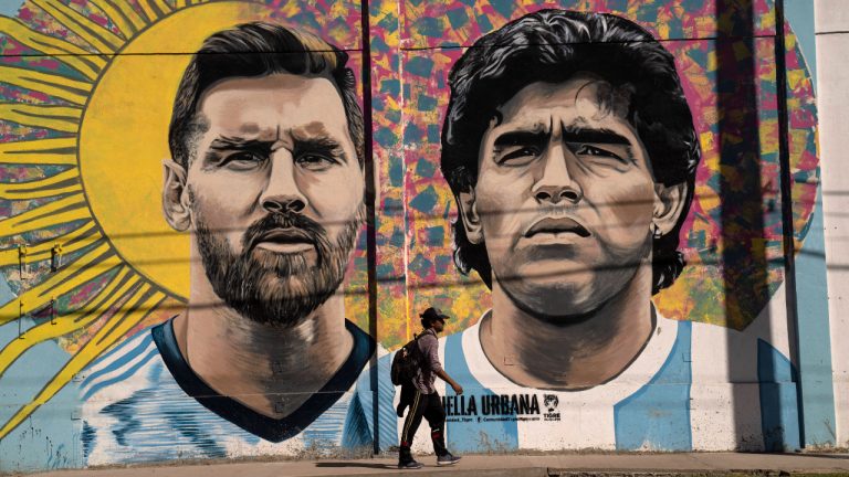 A pedestrian walks past a mural depicting soccer legends Lionel Messi and Diego Maradona, in Buenos Aires, Argentina, Tuesday, Nov. 1, 2022. (Rodrigo Abd/AP)