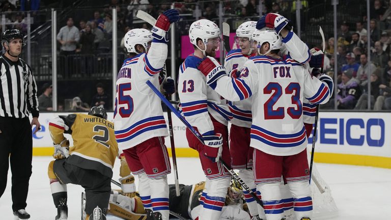 New York Rangers left wing Alexis Lafreniere (13) celebrates with teammates after scoring against the Vegas Golden Knights during the third period of an NHL hockey game Wednesday, Dec. 7, 2022, in Las Vegas. (John Locher/AP)