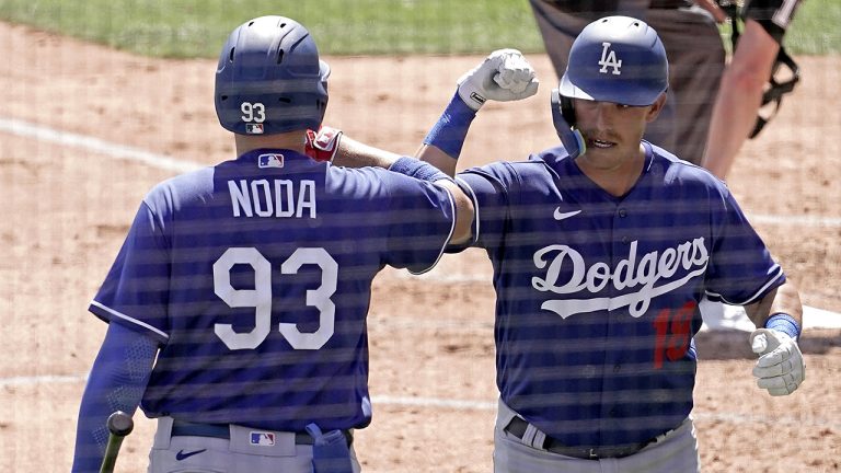 Los Angeles Dodgers' Jake Lamb (18) celebrates with Ryan Noda (93) after hitting a solo home run during the third inning of a spring training baseball game against the Chicago White Sox Monday, March 21, 2022, in Glendale, Ariz. (Charlie Riedel/AP)