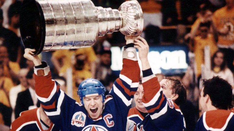 Edmonton Oilers' captain Mark Messier, center, along with his teammates holds the Stanley Cup above his head in voctory after the Edmonton Oilers defeated the Boston Bruins, 4-1, to win the Stanley Cup series in Boston May 1990. Former Oilers head scout Barry Fraser, whose shrewd draft picks helped build a hockey dynasty in Edmonton, has died, the team announced Sunday. He was 82. (CP Archives)
