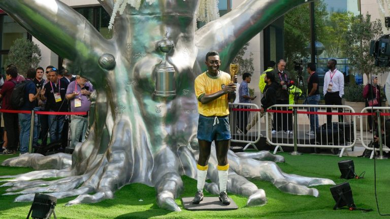 A life-size statue of Brazilian soccer legend Pele is displayed during an Conmebol event to pay tribute to Pele in Doha, Qatar, Sunday, Dec. 11, 2022. (Andre Penner/AP)