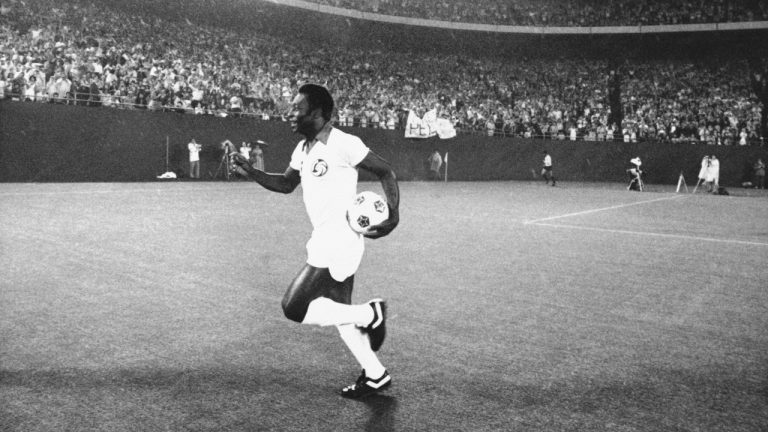 In this Aug. 25, 1977 file photo, New York Cosmos player Pele runs onto the field after his introduction before a crowd prior to a game against Rochester Lancers in Giants Stadium in East Rutherford, N.J. (Ray Stubblebine/AP)