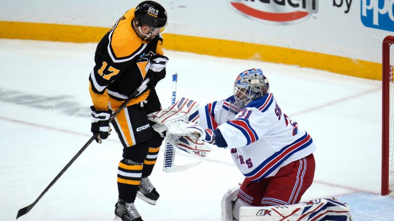 Pittsburgh Penguins' Bryan Rust (17) leaps out of the way of a shot in front of New York Rangers goaltender Igor Shesterkin during the first period of an NHL hockey game in Pittsburgh. (Gene J. Puskar/AP)