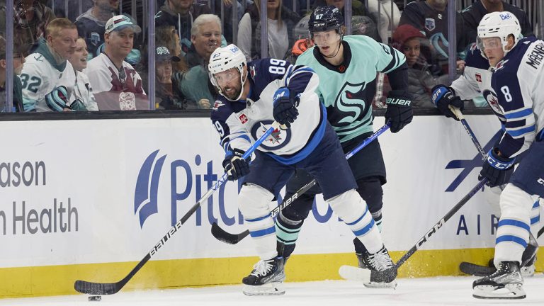 Winnipeg Jets centre Sam Gagner (89) skates with the puck ahead of Seattle Kraken center Morgan Geekie (67) during the first period of an NHL hockey game, Sunday, Nov. 13, 2022, in Seattle. (John Froschauer/AP)