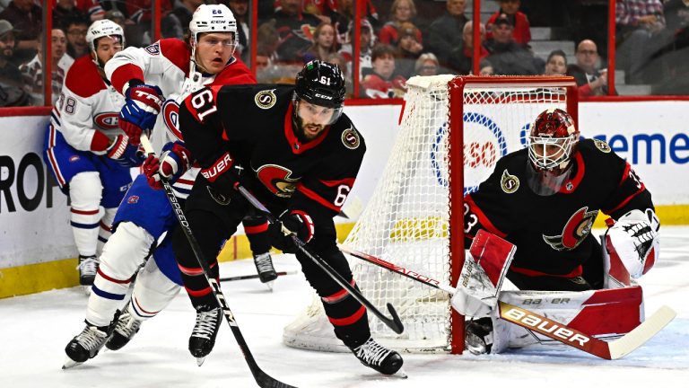 Ottawa Senators centre Derick Brassard (61) battles for the puck with Montreal Canadiens defenceman Johnathan Kovacevic (26) as goaltender Cam Talbot (33) looks on, during first period NHL hockey action in Ottawa, on Wednesday, Dec. 14, 2022. (Justin Tang/CP)