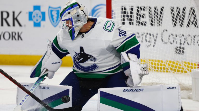 Vancouver Canucks goaltender Spencer Martin (30) makes a pad save during the first period of an NHL hockey game against the Buffalo Sabres, Tuesday, Nov. 15, 2022, in Buffalo, N.Y. (Jeffrey T. Barnes/AP)