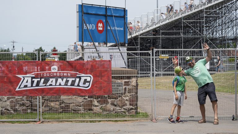 Saskatchewan Roughriders fans wearing watermelons on their heads make their way to the CFL Touchdown Atlantic game between the Toronto Argonauts and the Saskatchewan Roughriders at Acadia University in Wolfville, N.S., Saturday, July 16, 2022. (Darren Calabrese/CP)