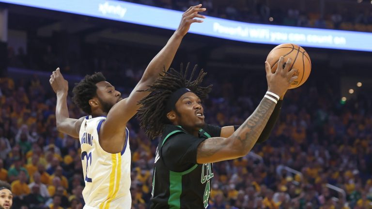 Boston Celtics center Robert Williams III, right, is defended by Golden State Warriors forward Andrew Wiggins during the first half of Game 5 of basketball's NBA Finals in San Francisco, Monday, June 13, 2022. (Jed Jacobsohn/AP Photo)