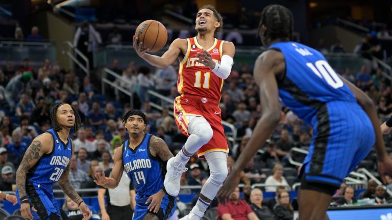 Atlanta Hawks guard Trae Young (11) goes up for a shot between a few Orlando Magic players during the first half of an NBA basketball game Wednesday, Nov. 30, 2022, in Orlando, Fla. (Phelan M. Ebenhack/AP Photo)