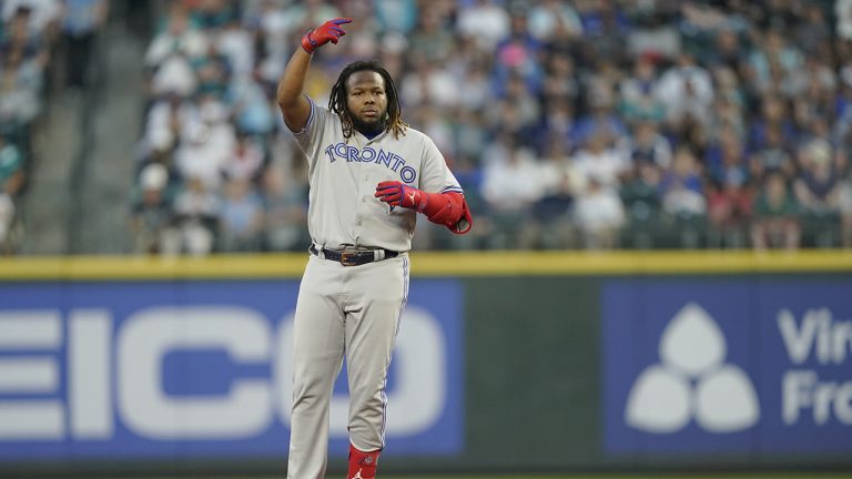 Toronto Blue Jays' Vladimir Guerrero Jr. gestures from second base after he lost his helmet running on a double during the fifth inning of the team's baseball game against the Seattle Mariners, Friday, July 8, 2022, in Seattle. (Ted S. Warren/AP)