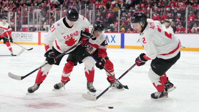 Canada’s Nathan Gaucher, left, and Nolan Allan, right, battle for the puck with Austria’s Tim Geifes during first period IIHF World Junior Hockey Championship action in Halifax on Thursday, December 29, 2022. (Darren Calabrese/CP)