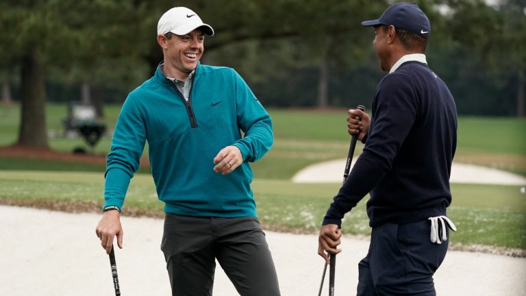 Tiger Woods is greeted by Rory McIlroy, of Northern Ireland during a practice round for the Masters golf tournament on Tuesday, April 5, 2022, in Augusta, Ga. They're set to team up for The Match on Dec. 10, against the pairing of Justin Thomas and Jordan Spieth (Charlie Riedel/AP Photo)