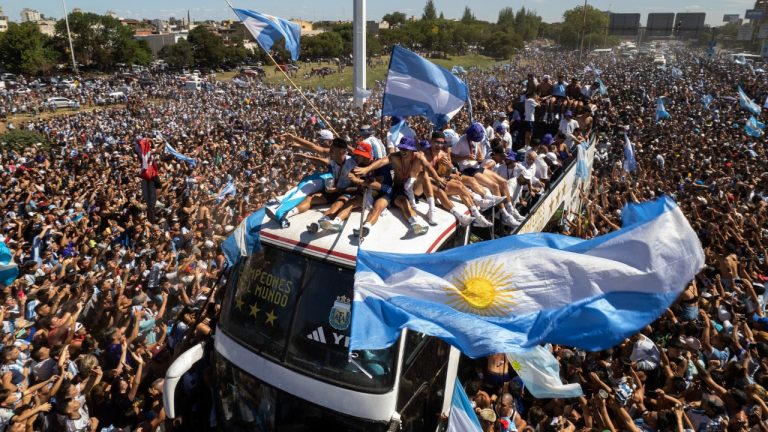 The Argentine soccer team that won the World Cup title ride on top of an open bus during their homecoming parade in Buenos Aires, Argentina, Tuesday, Dec. 20, 2022. (Rodrigo Abd/AP)