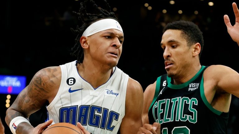 Orlando Magic forward Paolo Banchero, left, drives against Boston Celtics guard Malcolm Brogdon (13) during the second half of an NBA basketball game, Sunday, Dec. 18, 2022, in Boston. (AP Photo/Mary Schwalm)